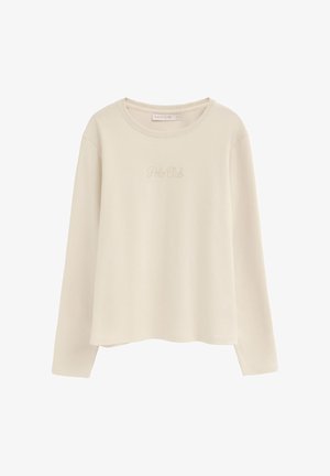 Chemise beige à manches longues et col rond avec une broderie discrète "Polo Club" sur la poitrine et une petite étiquette de marque à l'intérieur de l'encolure.