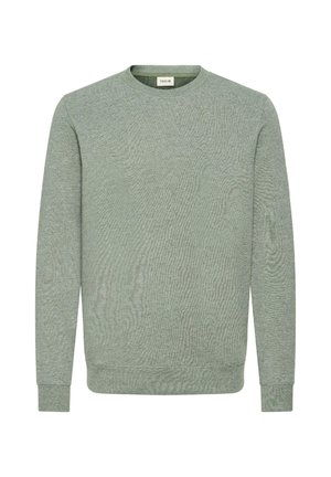 Zöld pulóver, kerek nyakkivágással, hosszú ujjakkal és strukturált anyagból. Ribbelt mandzsettákkal és aljjal rendelkezik, lágy, laza kialakítással.