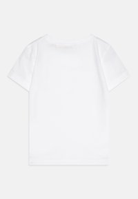 White cotton t-shirt with short sleeves, round neckline, and a smooth texture. Features a clean, unadorned design without patterns.