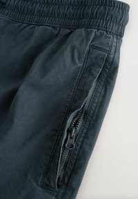 Navyfarbene Hose mit elastischem Bund verfügen über eine seitliche Reißverschlusstasche und ein glattes, strukturiertes Gewebe mit einem lässigen Design.