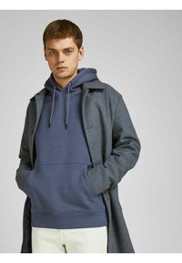 Gray long coat with a collar over a blue hoodie featuring a front pouch pocket. Soft fabric texture, simple design, and neutral color palette.