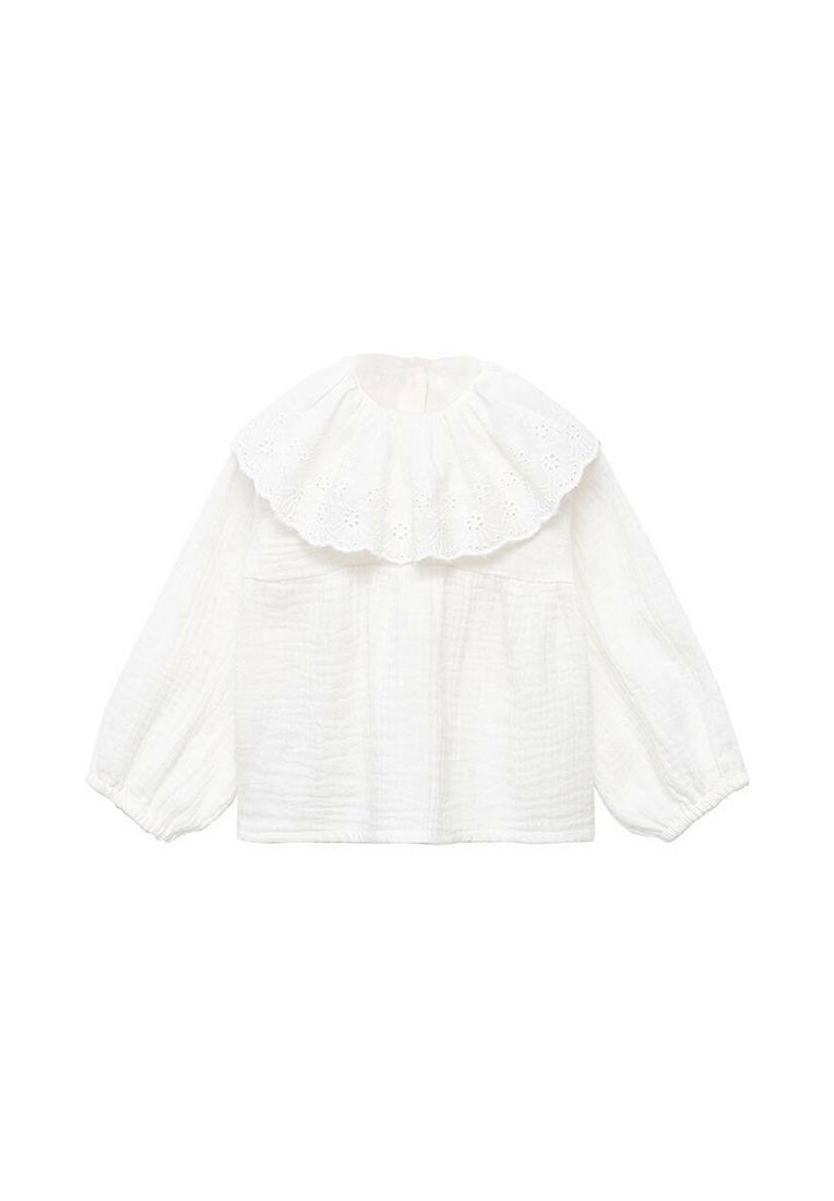 White cotton blouse with a large, broderie anglaise ruffled collar, long puff sleeves, and a textured fabric. Features two front pockets.