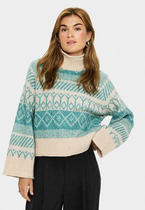 Geteiltes, cremefarbenes Strickpullover mit türkisfarbenen geometrischen Mustern und geripptem Rollkragen. Verfügt über breite, gerippte Bündchen und einen lockeren Schnitt.