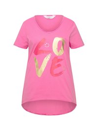 Pink cotton T-shirt with short sleeves, V-neck, and asymmetrical hem. Features bold, gold and colorful graphic text "LOVE" on the front.