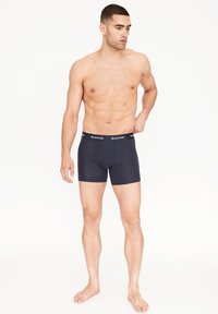 Námorní modré boxerky vyrobené z měkké, elastické látky s pohodlným páskem, na kterém je bílé slovo "Resterids".