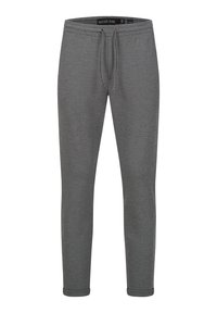 Grå joggebukser laget av mykt stoff, med elastisk liv med snor, avsmalnede ben og ribbestrikket nederkant. Strukturell finish.