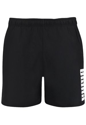 Black shorts with an elastic waistband, side pockets, and bold white lettering on the left leg. Made from lightweight fabric.