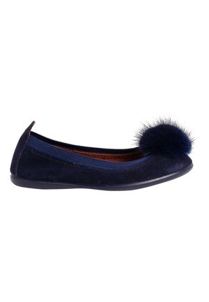 Navy blue suede ballet flat with a round, navy pom-pom on the toe, elastic side panels, and a flexible black rubber sole.