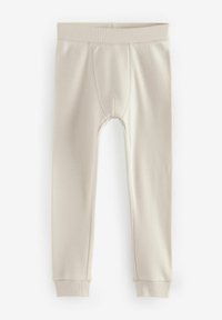 Lichtbeige lange leggings met een geribbelde textuur, voorzien van een versterkte voornaad en een elastische tailleband, taps toelopend bij de enkels.