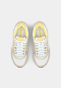 Shoe featuring a mesh and suede upper in light beige and white, with yellow accents, white laces, and a cushioned yellow-lined interior.
