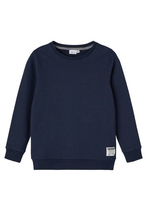 Granatowa bluza z miękkiego materiału, z okrągłym dekoltem, długimi rękawami i ściągaczami na mankietach. Na przedniej dolnej części znajduje się metka.