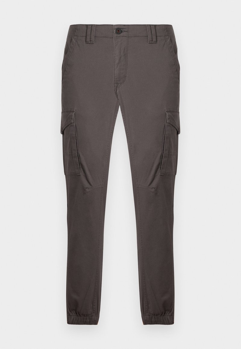 Pantalon cargo en tissu gris foncé, avec une coupe décontractée, des poignets élastiques, deux poches latérales et des coutures renforcées aux genoux.