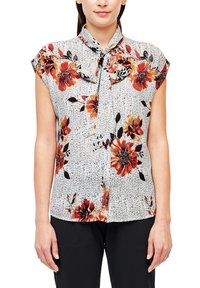 Blusa a maniche corte con un motivo floreale arancione e nero su sfondo a strisce bianche. Presenta un nodo al colletto.