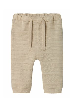Beige gebreide broek met een gestructureerd patroon. Voorzien van een elastische tailleband, trekkoord en taps toelopende manchetten. Zacht, lichtgewicht materiaal.