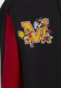Black sweatshirt featuring a graphic of Mickey and Minnie Mouse, with a large yellow "M" and red accents on the sleeves.