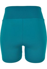 Shorts deportivos en color teal con una cintura alta, fabricados con un material liso y elástico. Presentan costuras planas y un diseño minimalista.