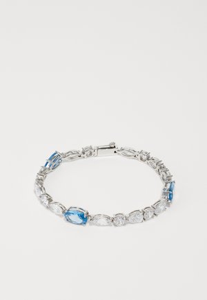 Silver bracelet with alternating blue and clear gemstones, featuring an oval cut and a clasp closure. Thin, linked chain design.