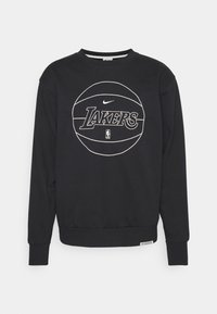 Sudadera negra de manga larga, con cuello redondo, que presenta un gráfico de baloncesto blanco y el texto "LAKERS". Tejido suave con puños acanalados.