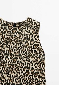 Leopard print sleeveless top in beige and black, featuring a round neckline and smooth, textured fabric. Simple design with no embellishments.