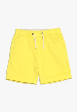 Keltaiset shortsit, jotka on valmistettu kevyestä materiaalista. Niissä on joustovyötärö, jossa on nyöri, sekä sivutaskut. Lyhyt lahkeensuu, johon on ommeltu reuna.