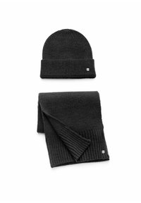 Black knit beanie and matching ribbed scarf. Both items feature a subtle logo accent. Material has a soft, textured finish.