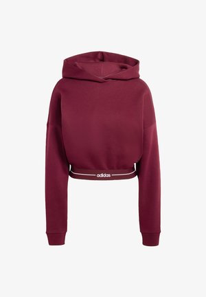 Vīnogu sarkana saīsināta kapučjakas džemperis ar aukliņu kapuci, garām piedurknēm un baltu zīmola jostu. Gluda auduma un vaļīgs piegriezums.