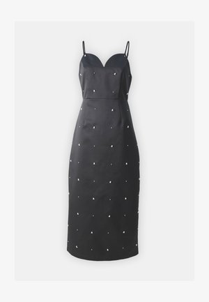 Black fitted dress with a sweetheart neckline, thin straps, and scattered metallic embellishments on a textured fabric.