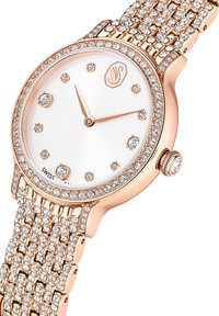 Roségouden polshorloge met kristalaccenten, witte wijzerplaat en een gestructureerde armband. Voorzien van een ronde kast en minimalistische uurmarkeringen. Zwitsers gemaakt.