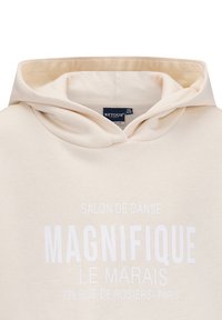 Felpa color crema in tessuto morbido. Presenta una tasca a marsupio e testo bianco che recita "MAGNIFIQUE LE MARAIS" sul davanti.