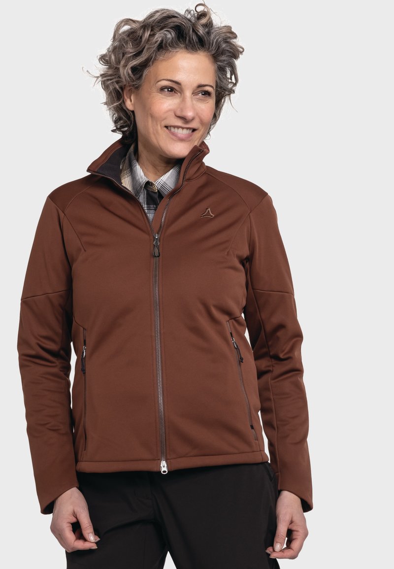 Braune Softshelljacke mit hohem Kragen, Reißverschluss vorne und zwei Seitentaschen. Der Stoff ist glatt mit leichtem Glanz und enthält ein Logodetail.