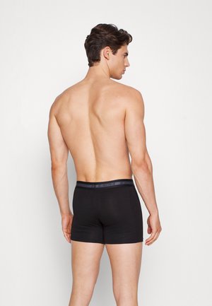 Sorte boxerunderbukser med en glat tekstur. Har en grå talje med "JBS UNDERWEAR" logo. Modellen vist bagfra.
