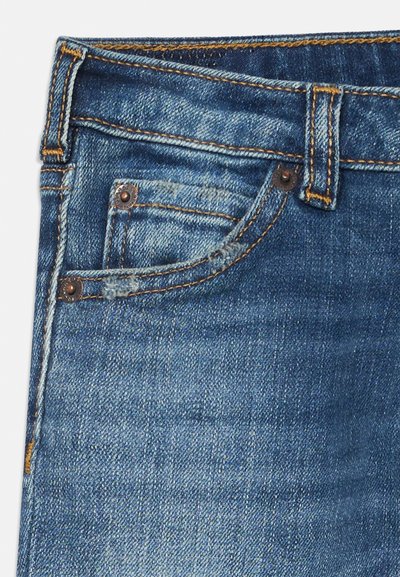 Denim jeans in a medium blue wash featuring orange stitching, a small front pocket, and metal hardware accents near the waistband.