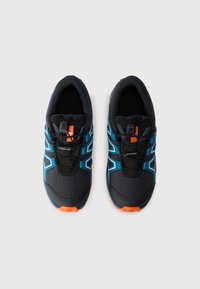 Black and blue athletic shoes with a textured upper, featuring an orange accent, a secure lacing system, and a durable sole.