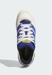 White and blue sneaker featuring a leather and mesh upper, round toe, white laces, and a black and yellow logo accent on the tongue.