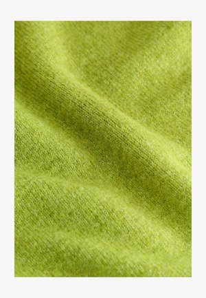 Tissu vert texturé avec un tricot fin. La teinte vibrante a une surface lisse et douce, présentant des variations subtiles de couleur et de tissage.