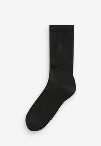 Calzino nero a coste con una texture liscia, caratterizzato da un discreto logo sul risvolto. Design di lunghezza standard per calzini crew.