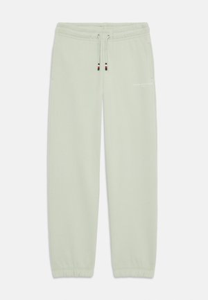 Pantalon de survêtement vert clair avec poignets élastiques, taille à cordon, poches latérales et petit logo "Tommy Hilfiger" sur la cuisse droite.