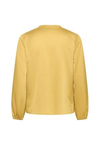 Gelbe Bluse mit langen Ärmeln, die eine glatte, glänzende Oberfläche aufweist, einen Rundhalsausschnitt und elastische Bündchen hat, mit einem einfachen, schlichten Design.