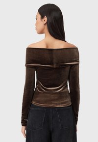 Brun fløjl off-shoulder top med lange ærmer, figursyet design, glat tekstur og en ren søm, der løber ned langs midten.