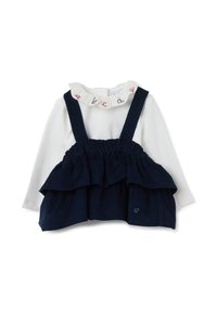Maglietta bianca a maniche lunghe con collo arricciato e bretelle in velluto a coste blu navy con rouches sovrapposte. Piccolo cuore in rilievo sul davanti.