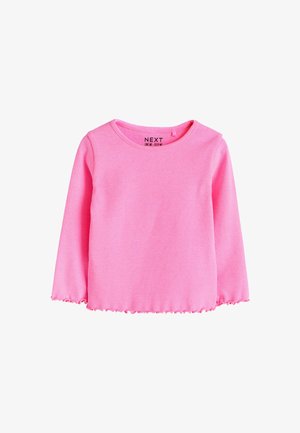 Růžový top s dlouhým rukávem s vroubkovanou strukturou a vroubkovaným lemem. Kulatý výstřih a štítek viditelný uvnitř límce. Hladký materiál, vhodný pro vrstvení.