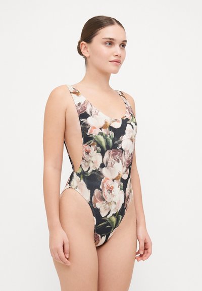 Floral-patterned one-piece swimsuit with a black background, low cut sides, wide straps, and a smooth fabric texture.
