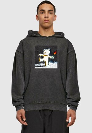 Dark gray hoodie with a loose fit, featuring a central white bear graphic holding a torch, made of soft material with elastic cuffs.