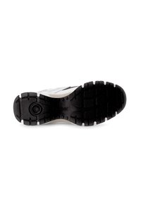 Black rubber sole with textured grip pattern, white midsole, and sleek upper design featuring a black and white color scheme.