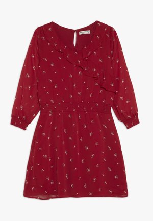 Rød kjole med lange ærmer med lille hvidt blomsterprint, flæset V-halsudskæring, elastisk talje og knaplukning med nøglehul bagpå.