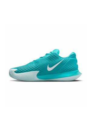 Teal athletic shoe with textured mesh upper, white Nike logo, and a translucent rubber sole featuring a herringbone tread pattern.