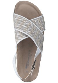 White sandal featuring crisscross woven straps in a beige texture, padded footbed, and a side buckle for secure fit.