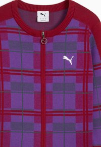 Red and purple plaid zip-up sweater with green lines and white Puma logo on the chest, featuring a round collar and a circular zipper pull.