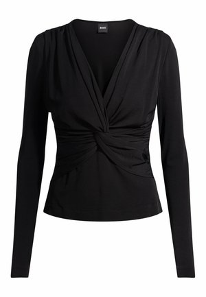 Svart långärmad topp med en åtsittande silhuett, V-ringning och tvistad tygdetalj vid midjan. Tillverkad i ett slätt, stretchigt material.