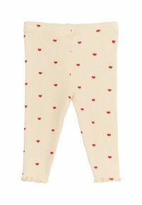 Beige bordás leggings, amelyeket szórt piros szívminták díszítenek, fodros szegéllyel a bokán és elasztikus derékpánttal.